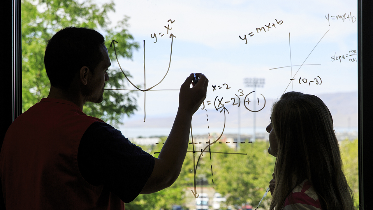 Students studying math on a window